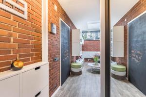 a room with a brick wall and two stools at Ferienwohnung Stillblick in Gersthofen