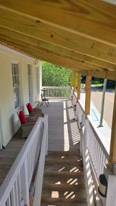 a porch with chairs and a wooden deck at Catherine's Palace in Vicksburg
