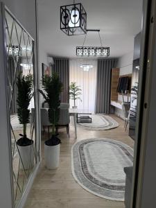 a living room with potted plants and a dining room at Чарвак дарвозаси люкс апартамент, дом в горах с видом in Khŭjakent +26 photos