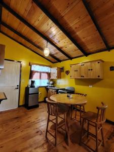 a kitchen with a table and chairs in a room at Cabaña Santa Rosa in Tecpán Guatemala