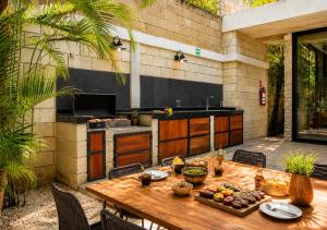a wooden table with food on top of a patio at Hum Living Luxury Villas in Tulum