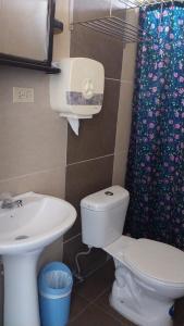 a bathroom with a toilet and a sink at Vami's House in Puerto Villamil +14 photos