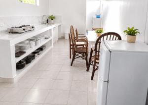 a kitchen with a table and chairs and a counter at Bluepango Guest House in Port Vila