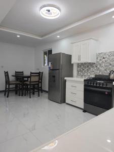 a kitchen with a refrigerator and a table with chairs at Tranquil Haven in Bellevue
