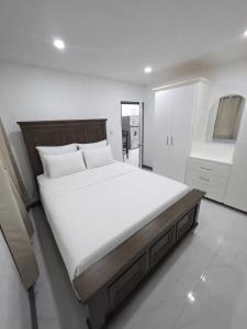 a bedroom with a large bed with white sheets at Tranquil Haven in Bellevue