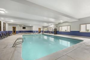 a large swimming pool in a room with chairs at Best Western Newberg Inn in Newberg