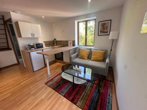 a living room with a couch and a table at Le loft sous les colombages in Gouffern en Auge +19 photos