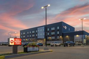 a building with a sign in a parking lot at Best Western Plus Dauphin in Dauphin