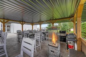 a patio with a grill and tables and chairs at Best Western Plus Dauphin in Dauphin