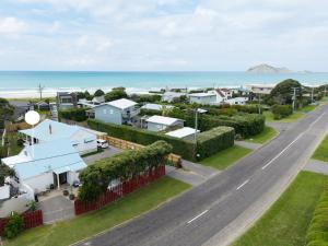 an aerial view of a town with the ocean at Waimarama Coastal Getaway in Waimarama