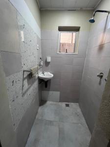 a bathroom with a sink and a window at Lynch Apartments 2 - Mimosa Chilanga in Lusaka
