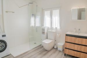 a bathroom with a toilet and a shower and a sink at Apartamento Aira in Villadepalos +61 photos