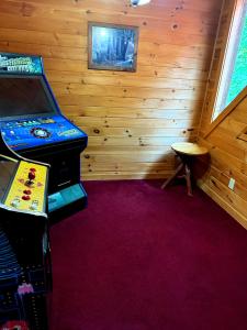 a wooden room with a video game console and a table at Sugar Bear in Sevierville