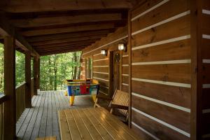 a porch of a cabin with a pool table at Sugar Bear in Sevierville