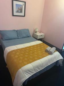 a bedroom with a large bed with a yellow blanket at Residencial Terminal Nunxá in Entroncamento +21 photos