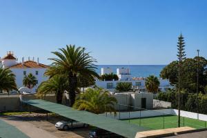 a tennis court on the roof of a building at Casa Mar by Living & Co in Albufeira