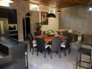 a dining room with a table and chairs at A Oca Praiana Suites in Ilha Comprida +10 photos