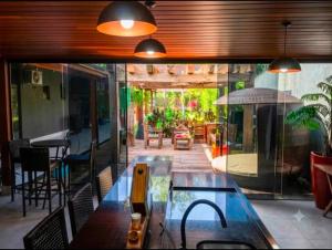 a room with a patio with a table and an umbrella at A Oca Praiana Suites in Ilha Comprida