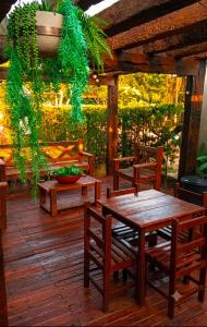 a wooden table and chairs on a wooden deck at A Oca Praiana Suites in Ilha Comprida