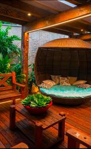 a bed on a deck with a bowl of vegetables at A Oca Praiana Suites in Ilha Comprida