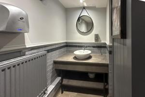 a bathroom with a sink and a mirror at Lobster Sheringham in Sheringham