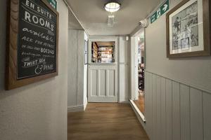 a hallway with a door and a sign on the wall at Lobster Sheringham in Sheringham