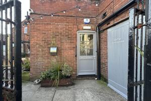 a brick building with a door and a garage at Lobster Sheringham in Sheringham +48 photos