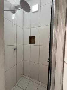 a bathroom with a shower with a glass door at KITNETS Kretzer Hinckel 1 - CENTRO in Alfredo Wagner