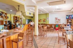 a restaurant with people sitting at tables in a room at Apartamento Aira in Villadepalos