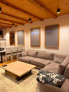 a living room with a couch and a table at Winter Dream Vlašić in Šišava +14 photos