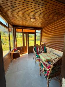 a room with a table and chairs and windows at Winter Dream Vlašić in Šišava