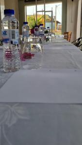a long table with bottles of water on it at Kër Mouna MJN Hotels in Diass +1 photo
