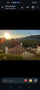 a picture of a sunset on a television screen at Sunshines on the sea in Almuñécar