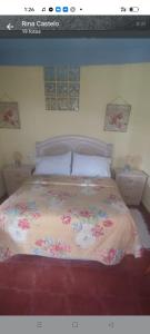 a bedroom with a bed with a floral bedspread at Sunshines on the sea in Almuñécar