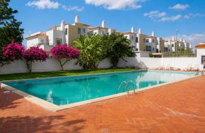 a swimming pool in front of a building at Casa Mar by Living & Co in Albufeira