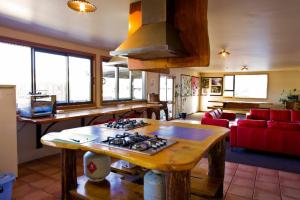 a kitchen and living room with a stove top at Dusky Lodge in Kaikoura