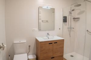 a bathroom with a toilet and a sink and a shower at Habitaciones Aira in Villadepalos +80 photos