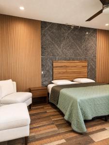 a bedroom with a bed and two chairs in it at Hotel Boutique Luciérnaga Xochitepec in Chiconcuac +36 photos