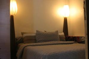 a bedroom with two lamps on the wall and a bed at Hobbiton in Agadir