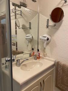 a bathroom with a sink and a mirror at Kaan Pansiyon in Bartın
