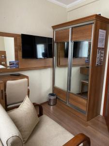 a living room with a couch and a tv at Kaan Pansiyon in Bartın