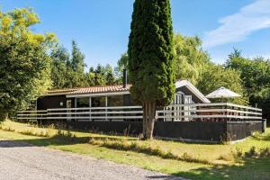 a house with a tree in front of it at 8221-Vordingborg-Gogeurtvej-13 in Vordingborg