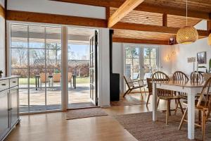 a kitchen and living room with a table and a dining room at 1087-Stege-Berberisvej-7 in Stege