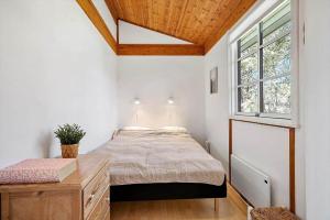 a bedroom with a bed and a window at 1087-Stege-Berberisvej-7 in Stege