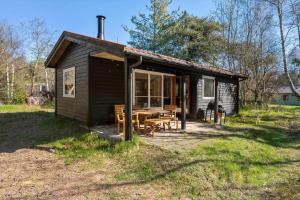 a small cabin with a picnic table in front of it at 2036-Stege-Solvgranen-16 in Stege