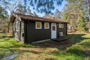 a small shed with a door in a yard at 2036-Stege-Solvgranen-16 in Stege +17 photos