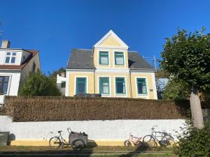 three bikes parked on a wall in front of a house at Casa Ricardo in Svendborg +12 photos