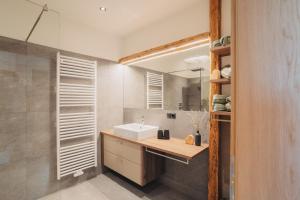 a bathroom with a sink and a mirror at Innersennerhof in Rifiano +19 photos