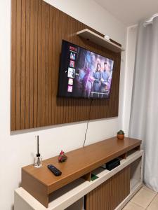 a flat screen tv on a wall in a room at Spazio Cristalli Comfort in Cuiabá