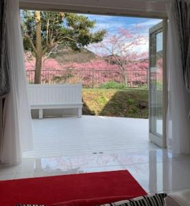 an open door with a bench in a room at Sea Shell Kawazu House in Kawazu